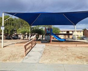 Coachella apartment for rent - a blue canopy over a playground in a park