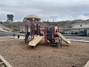 Globe apartment for rent - a playground with two slides and a climbing structure