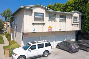 Sherman Oaks apartment for rent - A white car is parked in front of a garage.