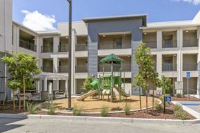 Morgan Hill apartment for rent - an apartment building with a playground in front of it