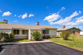 Douglas apartment for rent - A sunny day in a residential area with houses and a clear blue sky.
