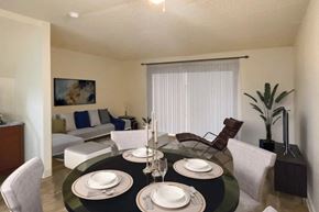 San Jose apartment for rent - A dining room with a black table set for two.
