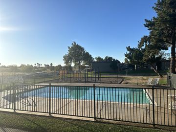 Fairfield apartment for rent - A black fence surrounds a blue pool in a sunny backyard.