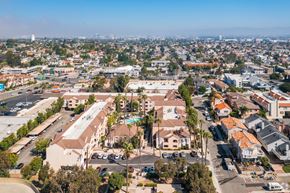 Redondo Beach apartment for rent - A bird's eye view of a residential area with apartment buildings and a parking lot.