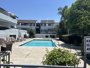 Reseda apartment for rent - a swimming pool in front of an apartment building