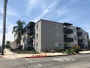 Van Nuys apartment for rent - A modern apartment building with a bicycle lane in front.