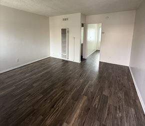 North Hollywood apartment for rent - A room with wooden flooring and a white wall.