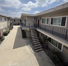 North Hollywood apartment for rent - A sunny day at the apartment complex with a staircase leading to the second floor.