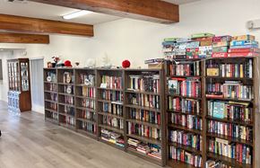 Verdugo City apartment for rent - A room with a long bookshelf filled with books.