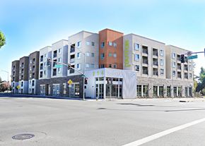 Santa Rosa apartment for rent - A street view of a multi-story building with the name "Dutton Flats" on the side.