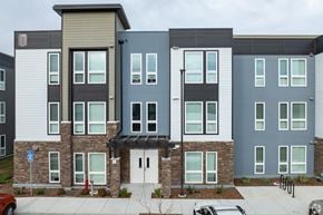 American Canyon apartment for rent - A building with grey and blue exterior walls and a white door.