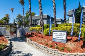 Pittsburg apartment for rent - The image shows the entrance to Marina Heights Apartments with a sign and a gate.