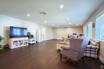 Pittsburg apartment for rent - A living room with a checkered chair and a television.