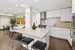 Monrovia apartment for rent - A kitchen with a bar area and a dining table.