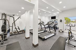 Monrovia apartment for rent - A well-lit gym with a variety of equipment including treadmills, stationary bikes, and weight machines.