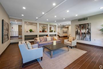 Monrovia apartment for rent - A spacious living room with a glass table and comfortable seating.