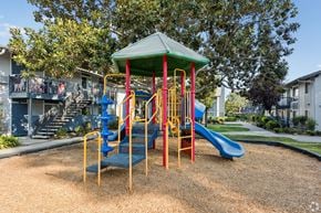 San Jose apartment for rent - A playground with a blue slide and a green roof.