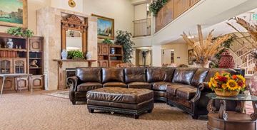 Inglewood apartment for rent - a living room with a leather couch and a table