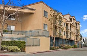 Inglewood apartment for rent - an apartment building with a staircase and trees in front of it