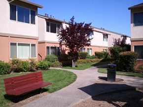 Sacramento apartment for rent - a red bench sitting in front of an apartment building