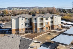 Folsom apartment for rent - A large, multi-story residential building with a parking lot in front.