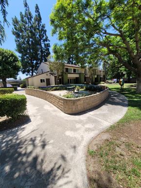 Santa Ana apartment for rent - a walkway with a fountain in front of a house