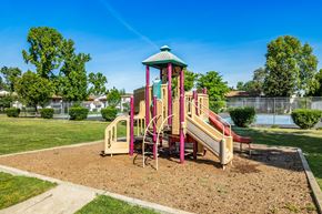Sacramento apartment for rent - A playground with a red and yellow slide and a green roof.