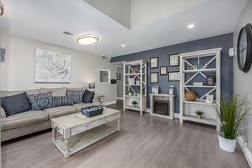 Sacramento apartment for rent - A living room with a grey couch and a wooden coffee table.