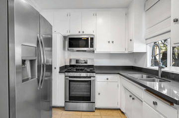 Los Angeles apartment for rent - A modern kitchen with white cabinets and stainless steel appliances.
