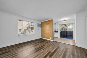Los Angeles apartment for rent - A room with wooden floors and a door leading to a balcony.