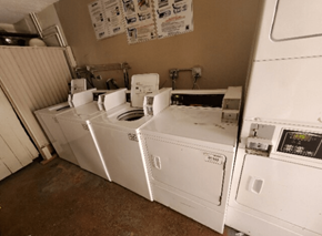 Van Nuys apartment for rent - A row of white washing machines in a laundry room.
