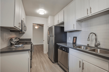 Los Angeles apartment for rent - A kitchen with white cabinets and stainless steel appliances.