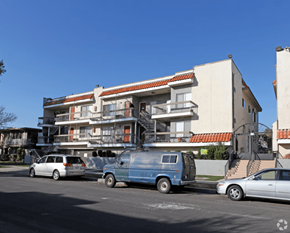Winnetka apartment for rent - A blue van is parked in front of a multi-story building.