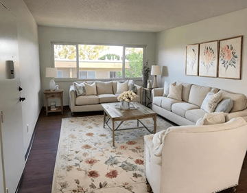 San Pedro apartment for rent - A living room with a white couch, a coffee table, and a rug with a floral pattern.