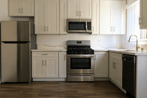Sherman Oaks apartment for rent - A modern kitchen with stainless steel appliances and white cabinets.