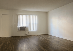 Sherman Oaks apartment for rent - A room with wooden floors and a window with blinds.