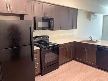 American Canyon apartment for rent - A kitchen with a black refrigerator and black stove.