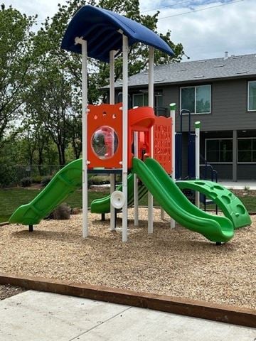 Santa Rosa apartment for rent - A playground with a green slide and a red and white structure.