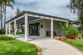Santa Ana apartment for rent - A house with a covered patio and a walkway leading to it at The Arbors Santa Ana, California, 92705