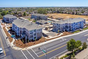 Elk Grove apartment for rent - A large apartment complex with multiple buildings and a parking lot.