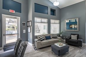 North Hollywood apartment for rent - A living room with a grey couch, a coffee table, and a chair at The Marquee Apartments, North Hollywood 91605