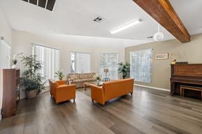 Verdugo City apartment for rent - A living room with a couch, two chairs, and a piano.
