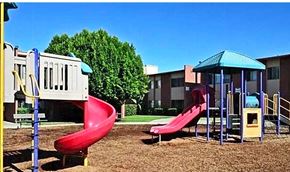 Sun Valley apartment for rent - A playground with a red slide and a blue canopy.
