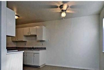 Sun Valley apartment for rent - A kitchen with white cabinets and a ceiling fan.