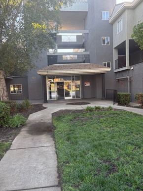West Sacramento apartment for rent - A building with a brown roof and a glass door.