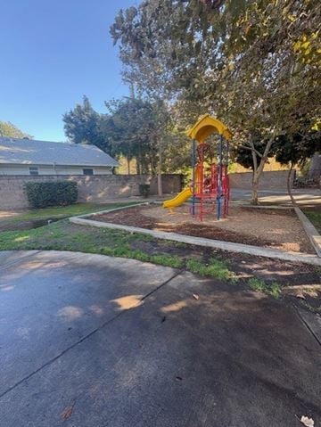 West Sacramento apartment for rent - A playground with a yellow slide and red and yellow swings.