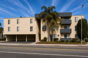 Van Nuys apartment for rent - A modern building with a parking garage in front.