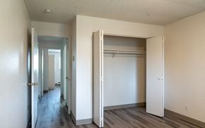 Washougal apartment for rent - an empty bedroom with a closet and a hallway with doors open