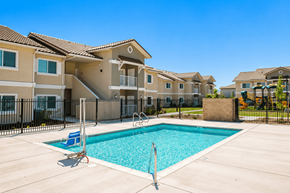 Live Oak apartment for rent - A swimming pool in front of a row of houses.