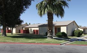 Coachella apartment for rent - a house with a palm tree in front of it